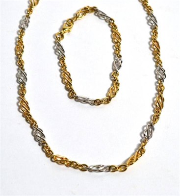 Lot 57 - A 9ct two coloured gold Celtic link necklace and bracelet set, 33g gross (2)