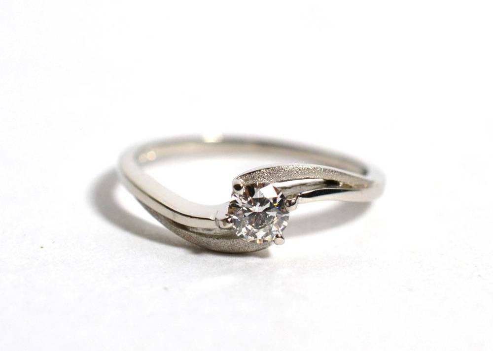 Lot 59 - A platinum solitaire diamond ring, a round brilliant cut diamond in a claw setting, to pierced matt