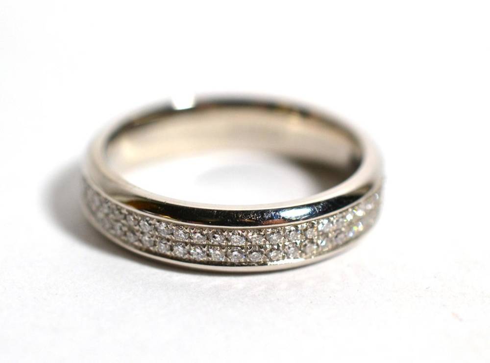 Lot 60 - A platinum diamond eternity ring, pavé set with two bands of round brilliant cut diamonds,...
