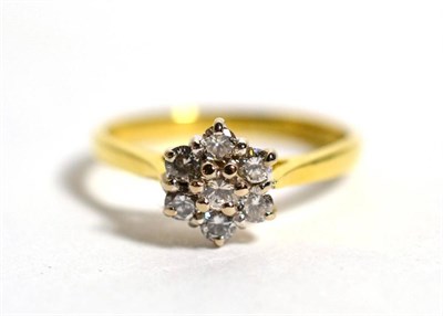 Lot 62 - An 18 carat gold diamond cluster ring, seven round brilliant cut diamonds in claw settings, to...