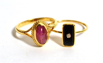 Lot 81 - An 18 carat gold onyx and diamond ring and an 18 carat gold cabochon ruby set ring, 5.3g gross (2)