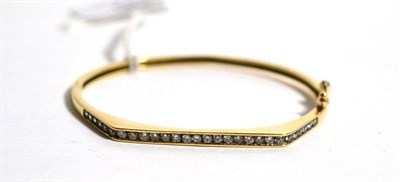 Lot 86 - A 9 carat gold paste set bangle, measures 5cm by 6cm, 11.3g