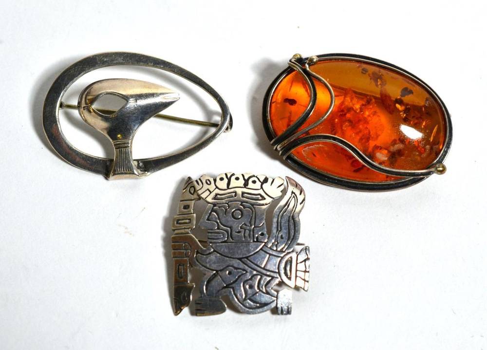 Lot 96 - A Roland Lantz Swedish silver brooch together with a Peruvian brooch stamped 925 and an amber...