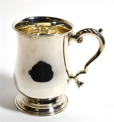 Lot 105 - A silver pint mug of George III style, Barker Brothers, Birmingham 1936, plain baluster form...