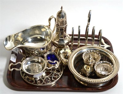 Lot 124 - A silver caster; tea strainer and stand; a pair of salts; a silver mounted glass coaster; and a...