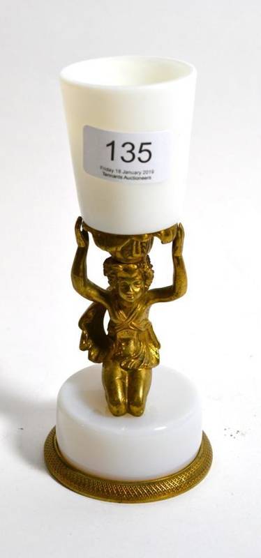 Lot 135 - An ormolu and opaque glass figural candlestick
