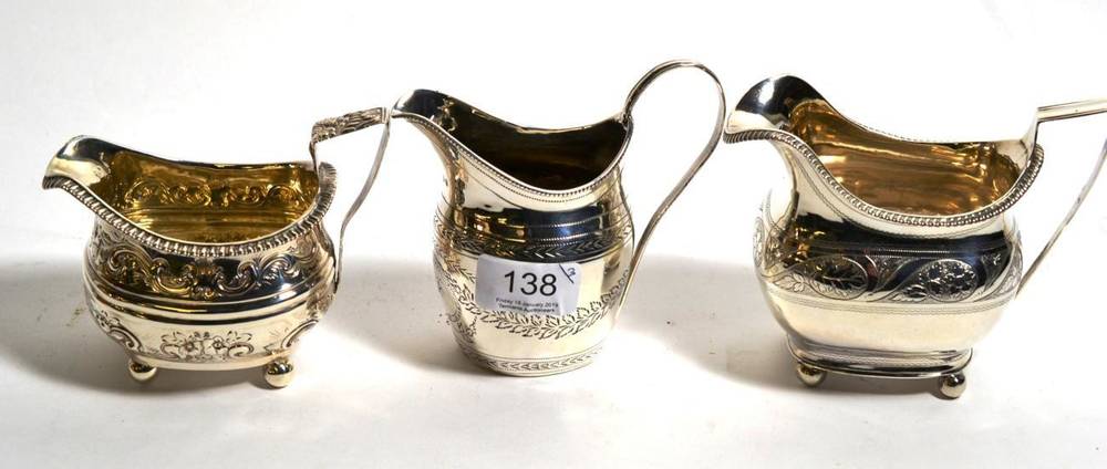 Lot 138 - A George III silver cream jug, London 1810, with gadroon rim on ball feet; together with two...