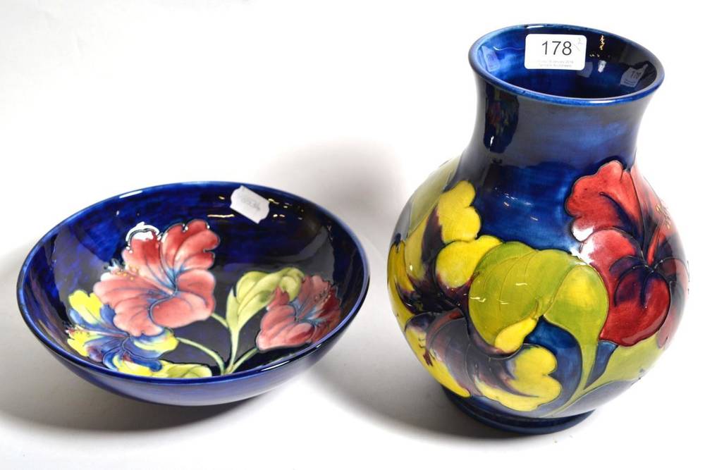 Lot 178 - Walter Moorcroft, a large blue ground Hibiscus bowl with original paper label and a similar...