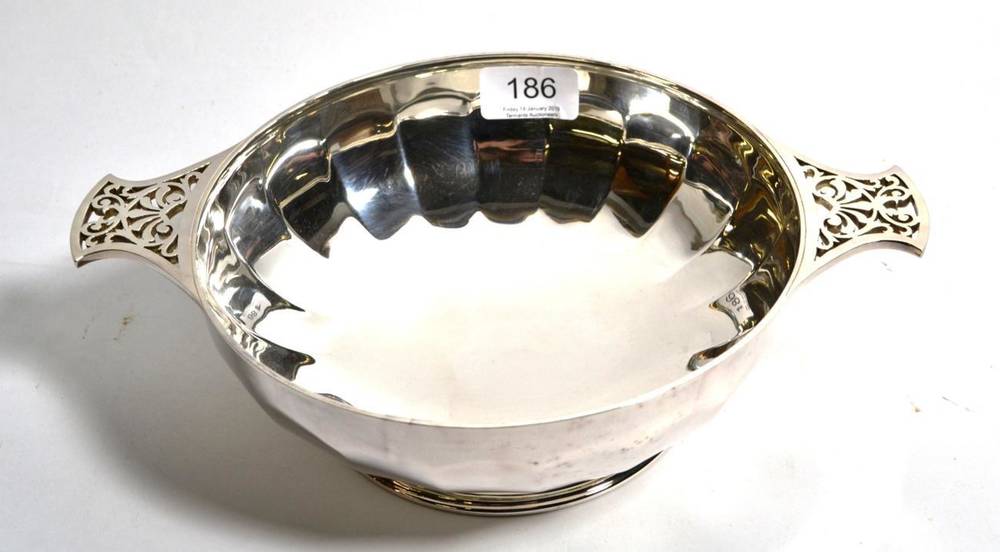 Lot 186 - A twin handled silver bowl, makers mark GM&S, Sheffield 1933, of panelled form with pierced handles