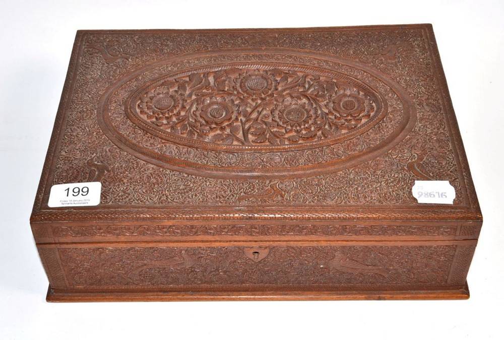 Lot 199 - An Indian carved wooden jewellery box, intricately decorated with flowers and birds, early 20th...