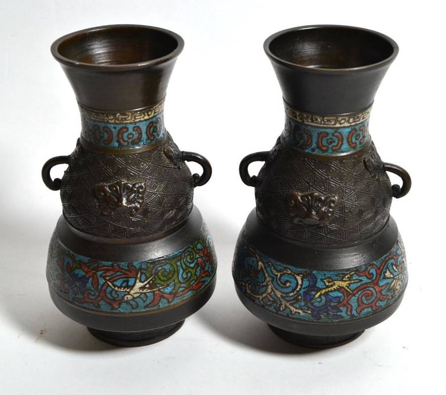 Lot 200 - A pair of oriental bronze and enamel twin handled vases