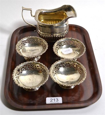 Lot 213 - A George III Irish silver cream jug, maker rubbed ''S*'', Dublin 1814; and a set of four...