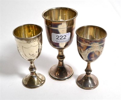 Lot 222 - Three early 20th century silver wine cups, each with vacant cartouche and marked for London,...