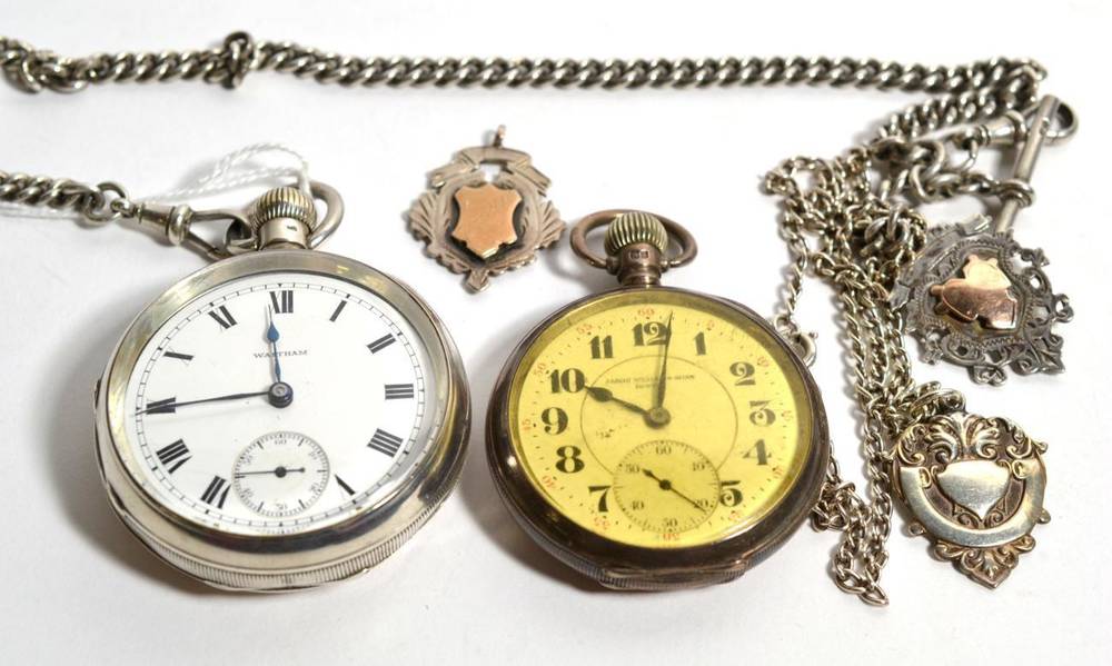 Lot 234 - A Waltham silver pocket watch, a silver Albert chain and three fobs