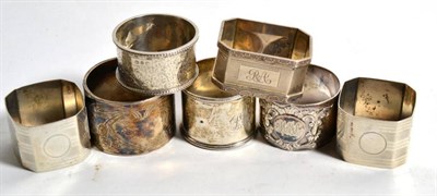 Lot 250 - Six English silver napkin rings, including a pair; together with one other unmarked white metal...