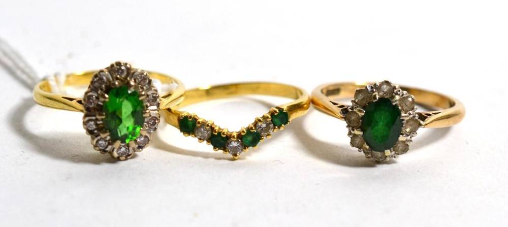 Lot 252 - A 18ct gold diamond and green stone cluster ring an 18ct gold diamond and emerald wishbone...