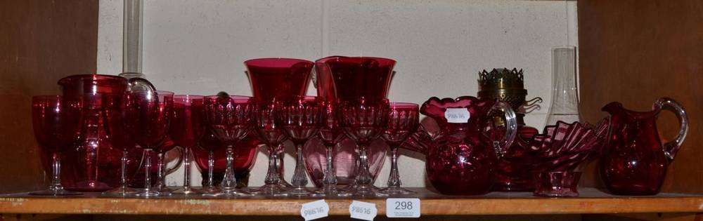 Lot 298 - A group of Victorian cranberry glass including bowls, glasses, oil lamps, jugs etc