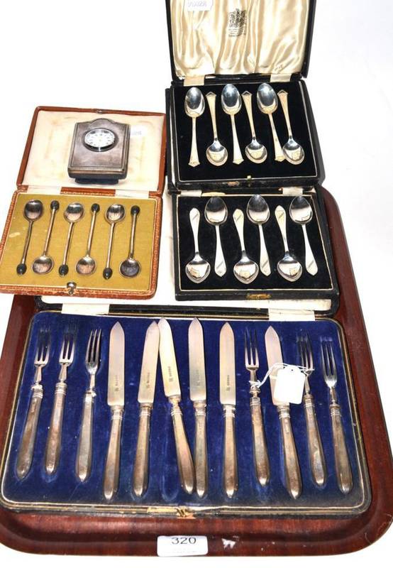 Lot 320 - Three cased sets of silver spoons; silver handled fruit knives and forks; and a silver clock