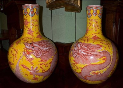 Lot 370 - A pair of large Chinese yellow ground bottle vases, hand painted dragon designs (2)