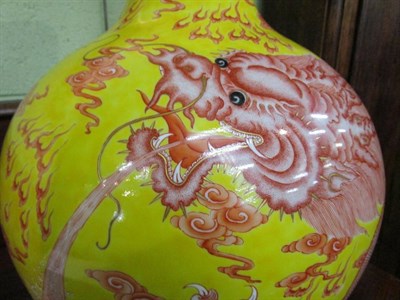 Lot 370 - A pair of large Chinese yellow ground bottle vases, hand painted dragon designs (2)