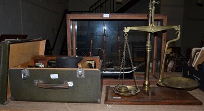 Lot 1002 - A scale model of a triple masted ship in a glazed case; a pair of brass scales with weights;...