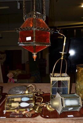 Lot 1010 - A middle Eastern style brass hanging lantern, a brass and coloured glass four-sided lantern,...