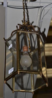 Lot 1124 - A set of four reproduction hexagonal brass lanterns