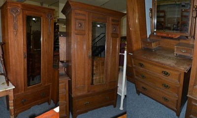 Lot 1137 - An early 20th century oak two piece bedroom suite comprising mirror fronted wardrobe and a dressing