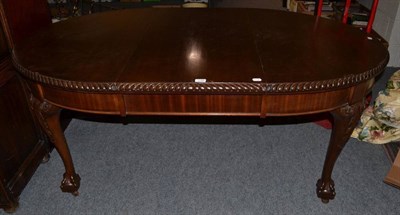 Lot 1148 - An oak wind out dining table with one leaf and winder