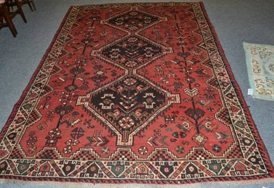 Lot 1156 - Kashgai carpet, South West Iran, the pale raspberry field with a column of hooked medallions...
