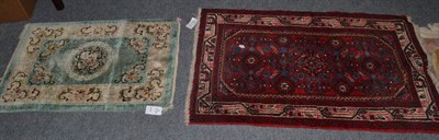 Lot 1157 - A small Chinese carpet; a Chinese silk rug and two other rugs (4)