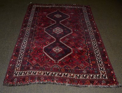 Lot 1160 - Kashgai Rug, South West Iran, the raspberry field with three serrated medallions enclosed by narrow