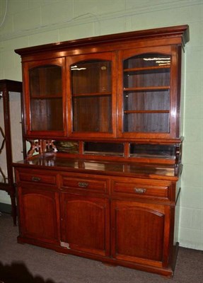Lot 1169 - An early 20th century mahogany bookcase cabinet by Moore & Hunton, London, the glazed upper section
