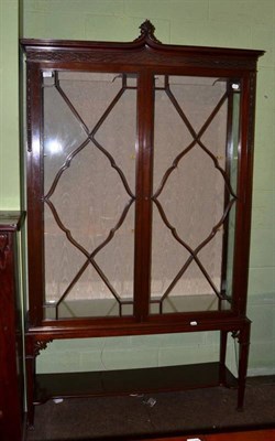 Lot 1170 - An Edwardian mahogany display cabinet with blind fret carved frieze and astragal glazed doors