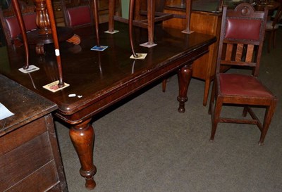 Lot 1187 - A Victorian dining table together with four studded red leather oak chairs