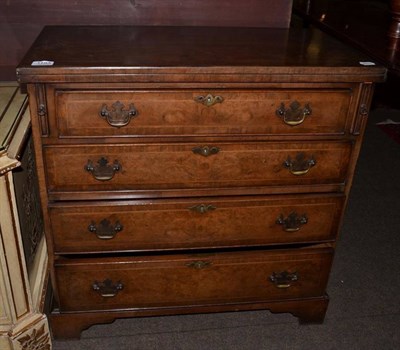 Lot 1193 - A reproduction burr walnut four drawer bachelors chest, the hinged leaf 71cm wide