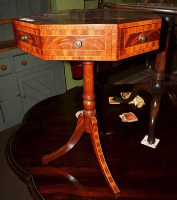 Lot 1196 - A reproduction mahogany and tulipwood banded octagonal shaped tripod table with revolving top, 69cm