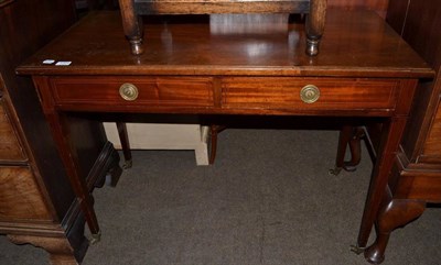 Lot 1204 - An Edwardian mahogany two drawer writing table on tapering legs, 107cm wide