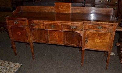 Lot 1211 - A George III inlaid mahogany break and bow front sideboard