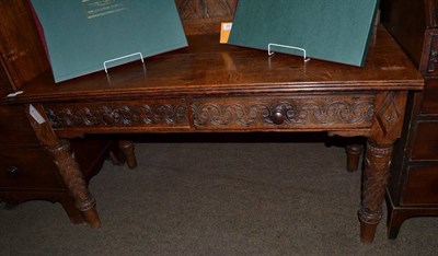 Lot 1217 - A Victorian carved oak serving table with superstructure back and two frieze drawers, 136cm wide