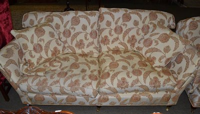Lot 1219 - A floral upholstered sofa with matching armchair, with cushions
