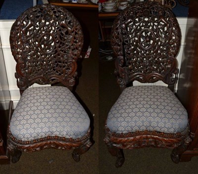 Lot 1226 - A pair of Chinese carved harlequin chairs