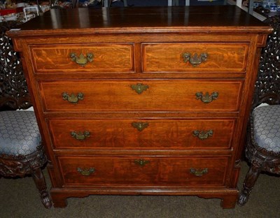 Lot 1227 - A George III oak and crossbanded chest of drawers, the two short over three long drawers with ivory