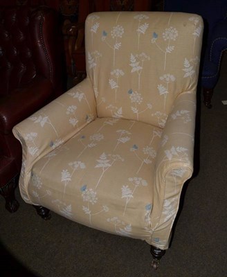 Lot 1234 - A Victorian upholstered armchair, later recovered in beige fabric, raised on turned legs, 85cm wide