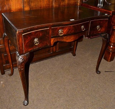 Lot 1244 - A 20th century mahogany serpentine shaped writing table in George III style