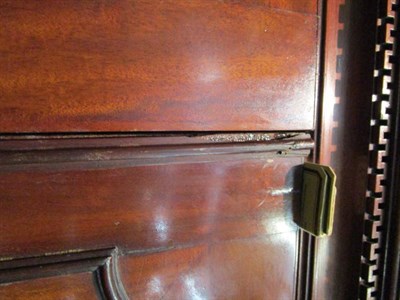 Lot 1261 - A George III mahogany linen press, the cupboard doors enclosing four siding trays