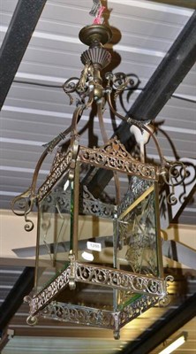 Lot 1288 - A patinated metal four-sided ceiling lantern with leaf and scroll arms
