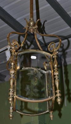 Lot 1290 - A brass four glass ceiling lantern with scroll arms