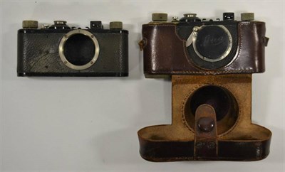Lot 2128 - Leica I Two Camera Bodies Only no.57126 (worn and case covering cracked) and no.48257 in...