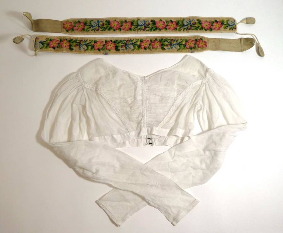 Lot 2058 - Circa 1830s White Muslin Spencer; Pair of Circa 1850s Gents Floral Embroidered Braces, worked...